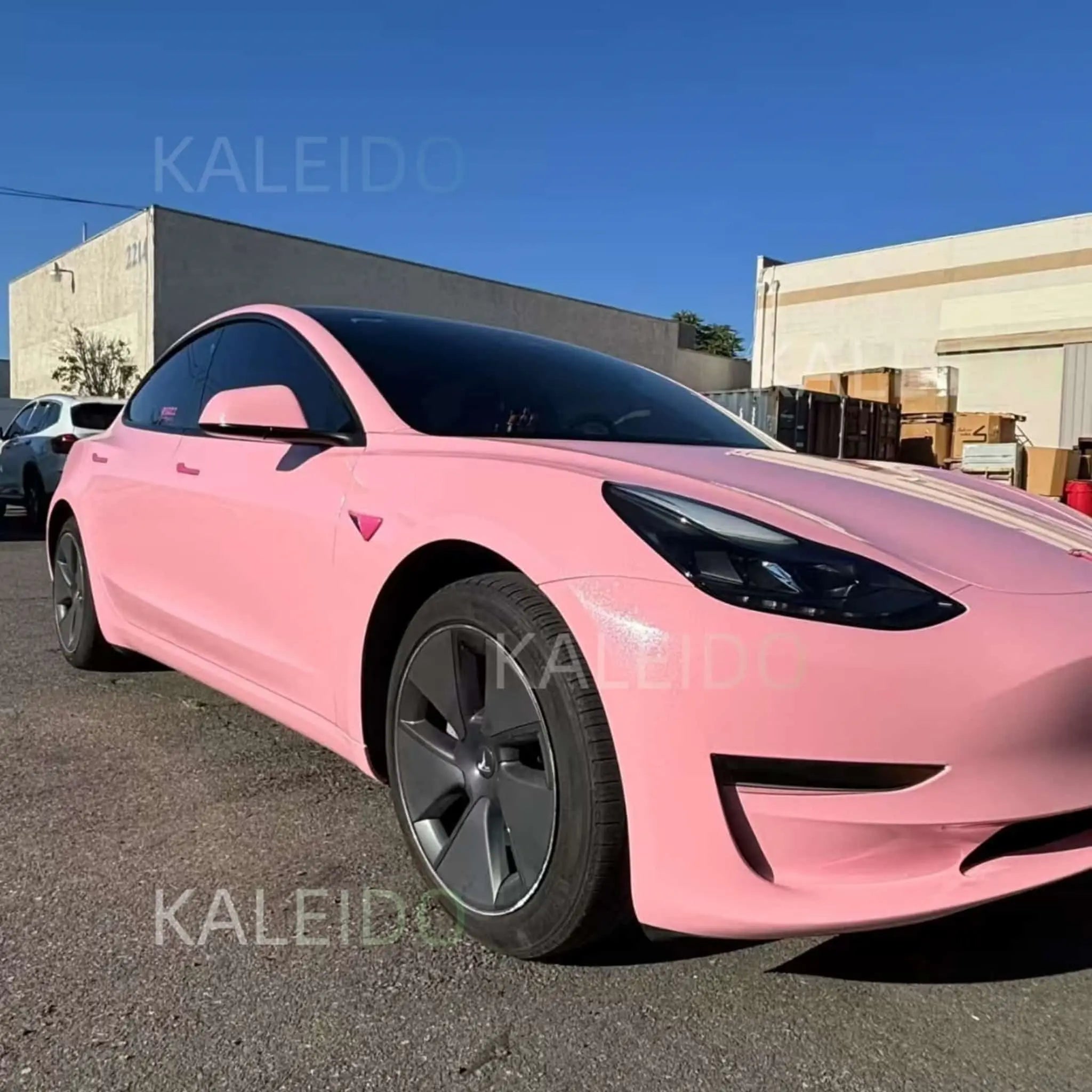 Wide front-right view of Diamond Iridescent Rouge Pink wrapped Tesla Model Y - Kaleido