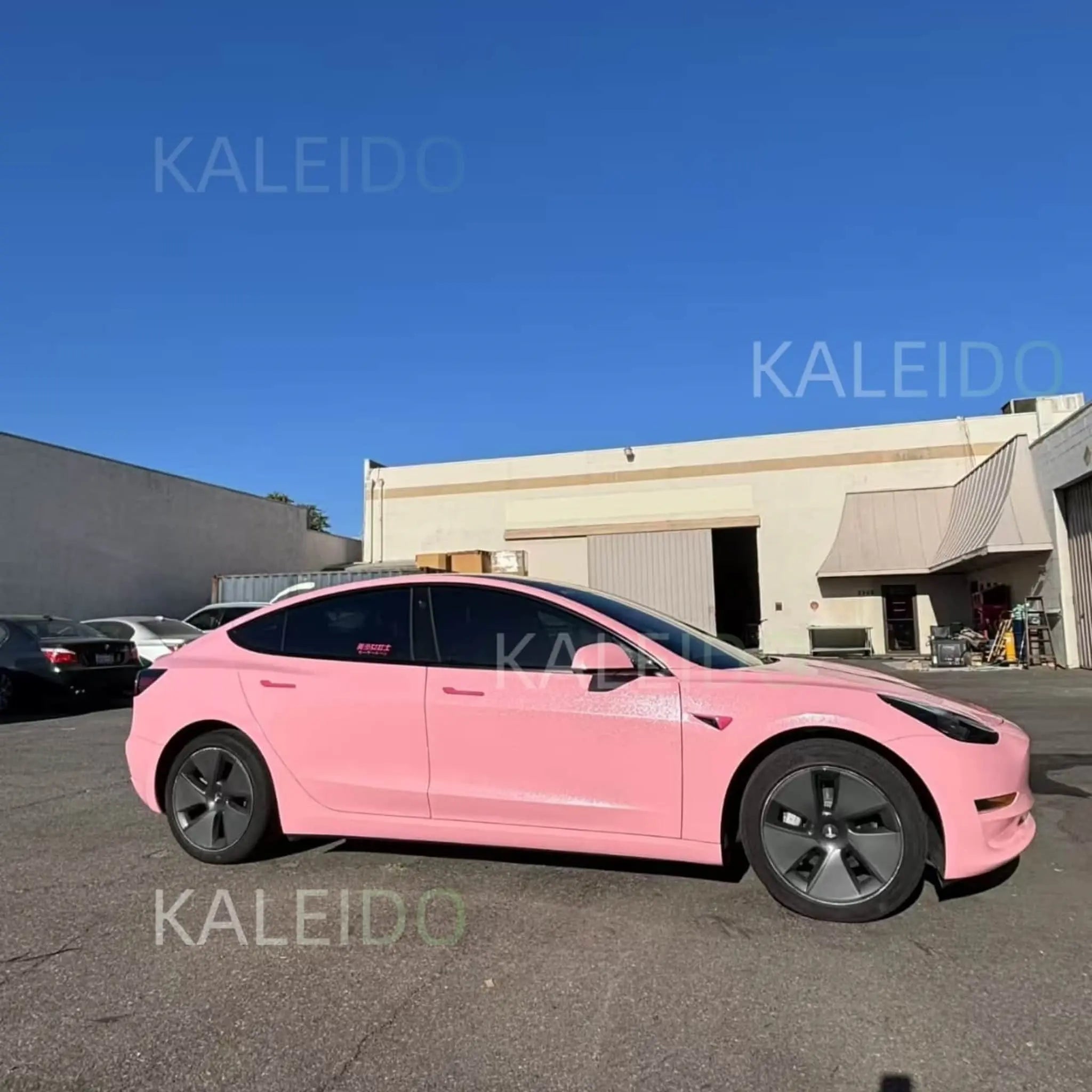 Right side profile of Tesla Model Y with Diamond Iridescent Rouge Pink pearl finish - Kaleido
