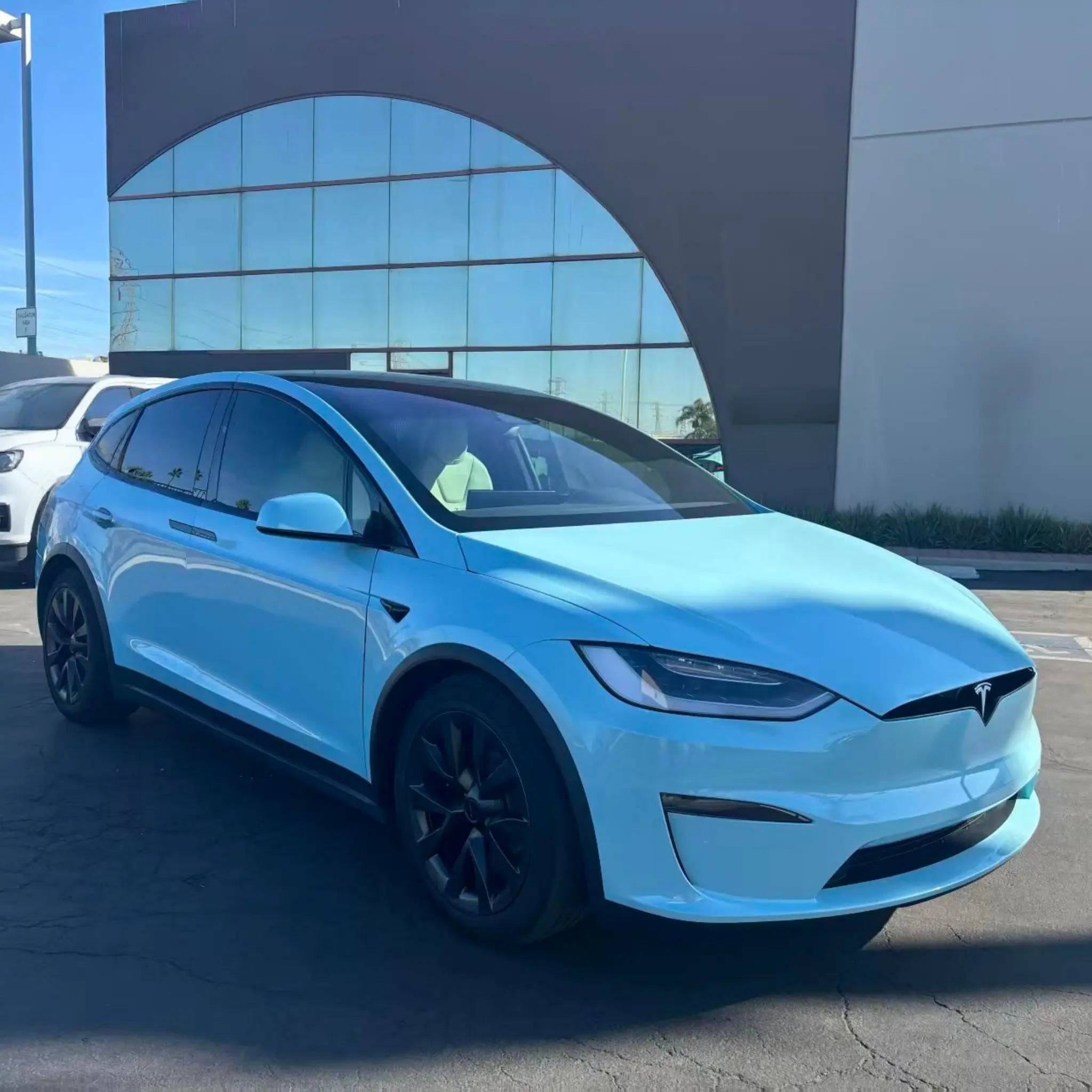 Front-right view of Tesla Model X in Diamond Iridescent Sea Mist Blue vinyl wrap - Kaleido