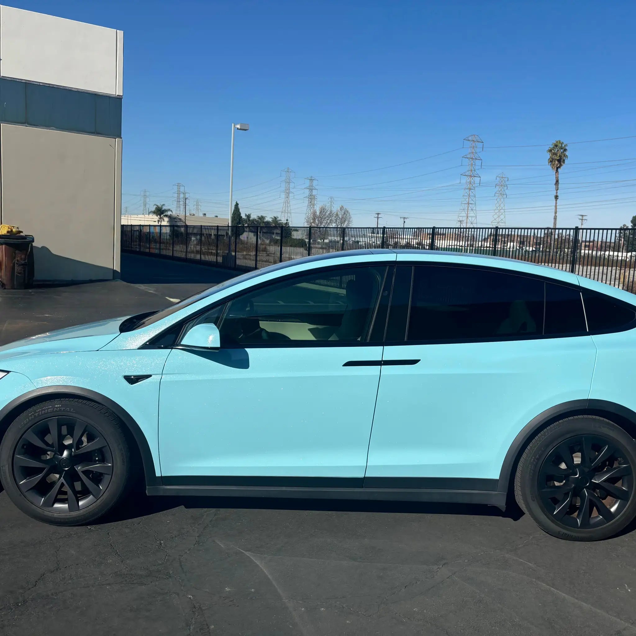 Left side profile of Tesla Model X with Diamond Iridescent Sea Mist Blue pearlescent film - Kaleido