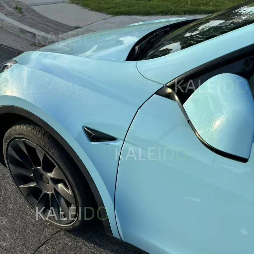 Detailed shot of Diamond Iridescent Sea Mist Blue vinyl on Tesla Model Y left front fender - iridescent shimmer - Kaleido