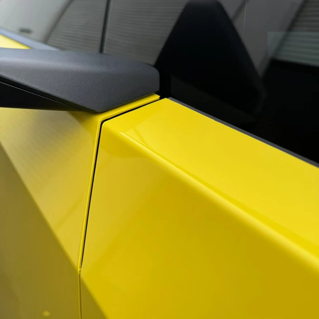 Macro detail shot showing the Gloss Corn Yellow vinyl application at the door gap of a Tesla Cybertruck - Kaleido
