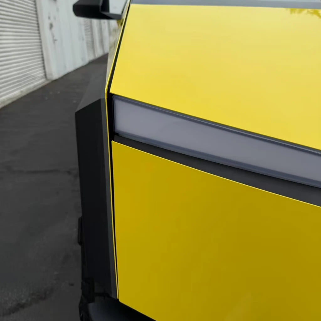 Gloss Corn Yellow vinyl on the front-right corner of the Tesla Cybertruck, showcasing its sharp lines - Kaleido