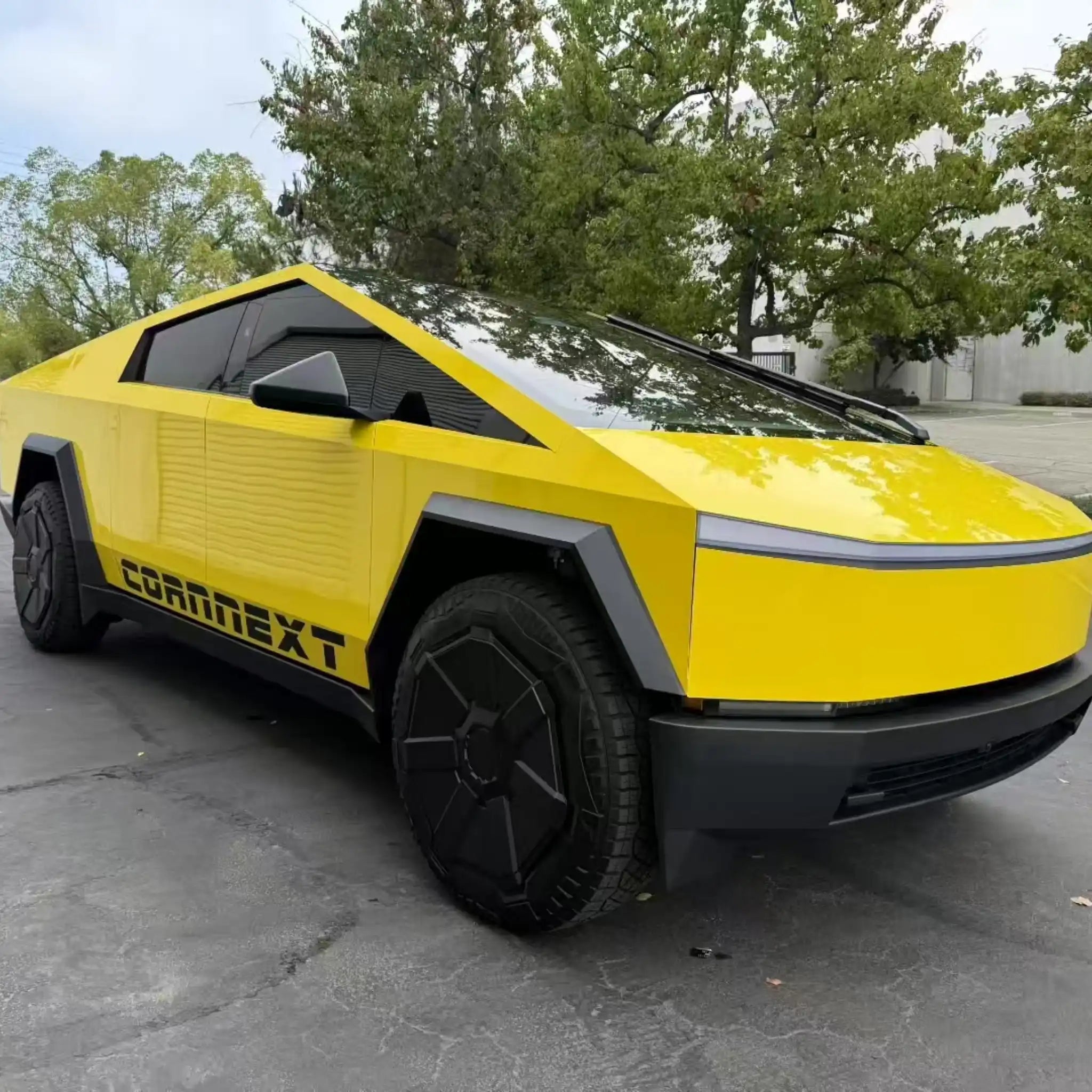 Wide front-right view of a Tesla Cybertruck wrapped in bright Gloss Corn Yellow vinyl - Kaleido