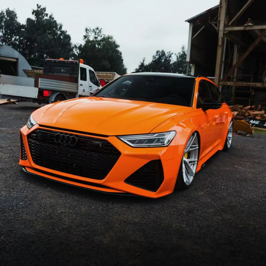 Audi RS6 Avant (C8) in Gloss Hermès Orange vinyl - front-left view - Kaleido