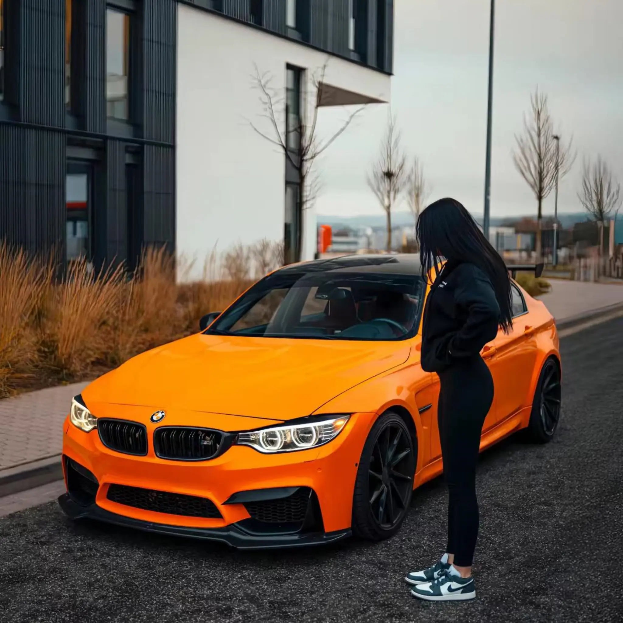 Gloss Hermès Orange vinyl on a modified BMW M3 (F80) sedan - front-left view - Kaleido