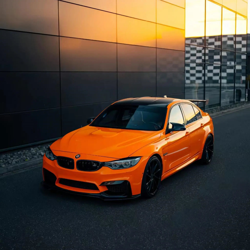 Wide front-left panoramic view of a modified BMW M3 (F80) in Gloss Hermès Orange - Kaleido