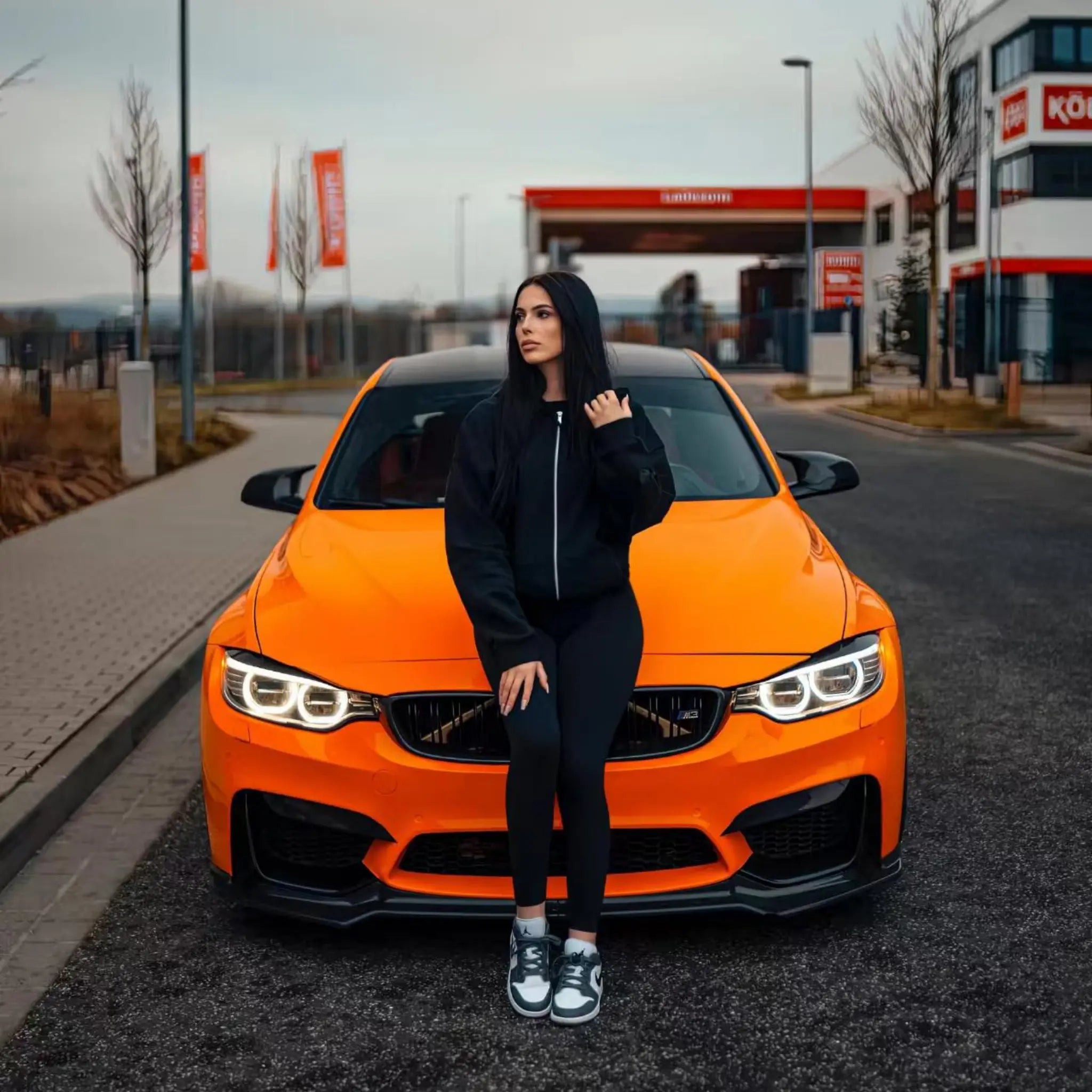 Front view of a modified BMW M3 (F80) in Gloss Hermès Orange wrap - Kaleido