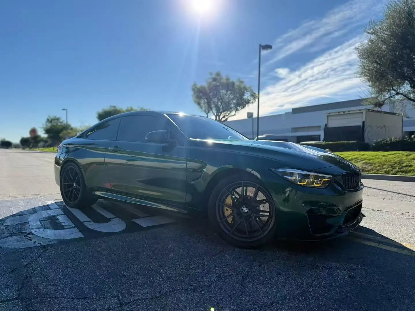Gloss Metallic Agate Green wrap on BMW M4 - front-right view with metallic green shimmer - Kaleido