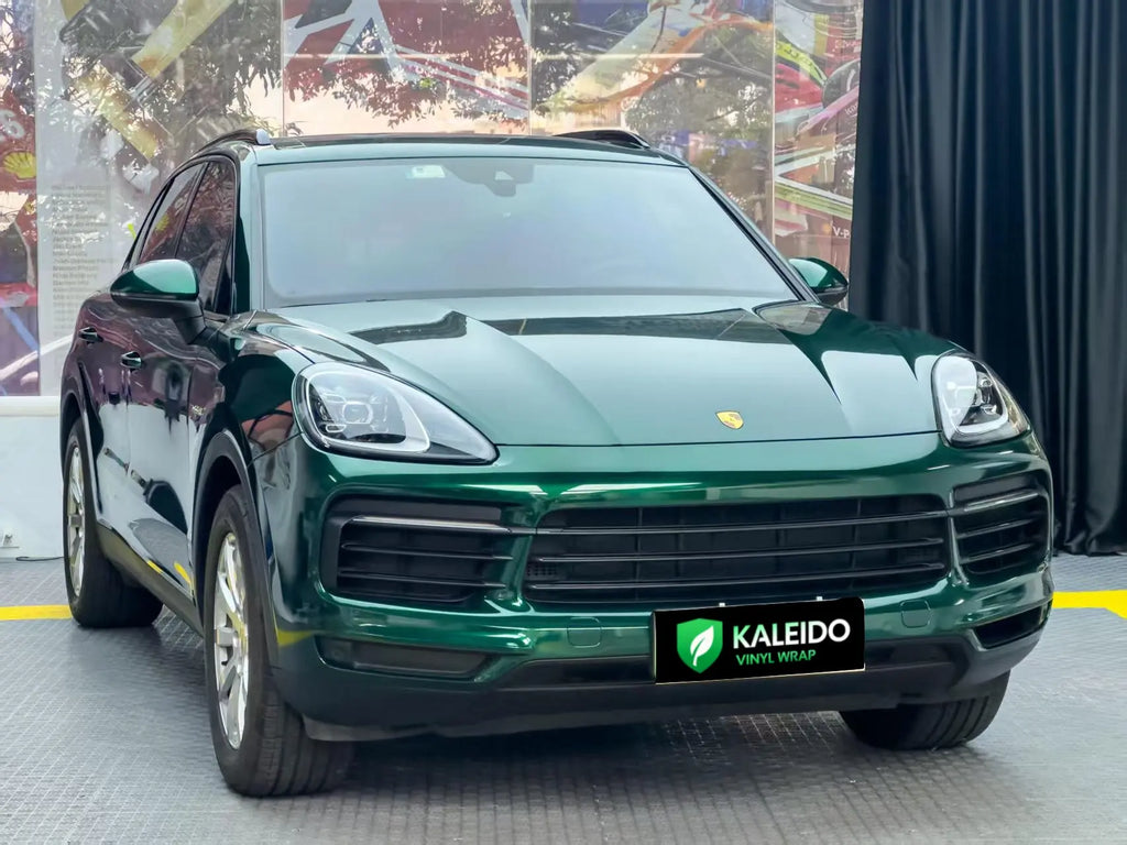 Porsche Cayenne in Gloss Metallic Agate Green vinyl - front view of luxury SUV - Kaleido