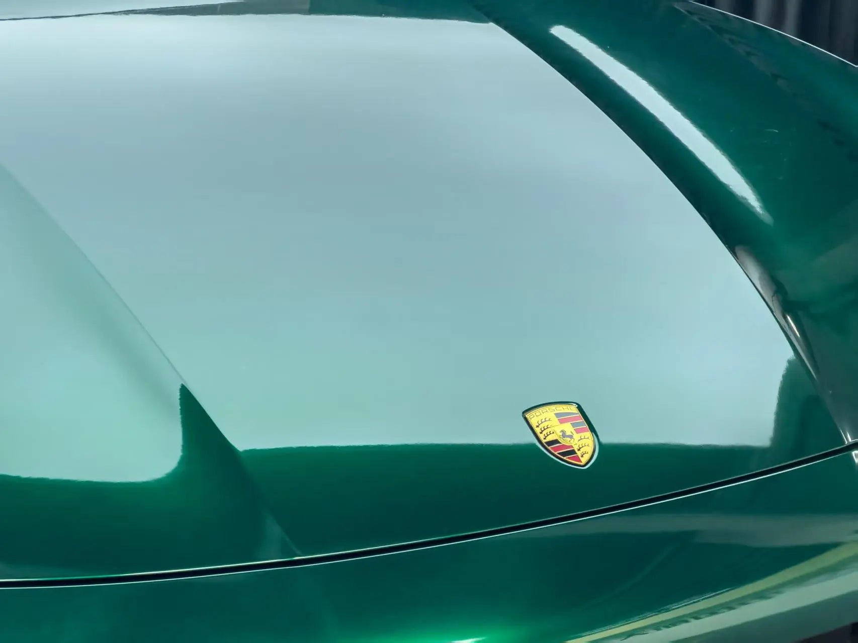 Macro detail of Gloss Metallic Agate Green wrap on Porsche Cayenne hood - metallic flake texture - Kaleido