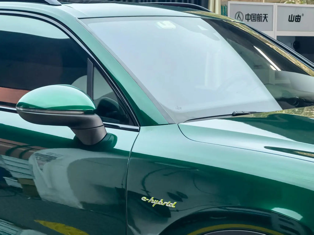 Close-up of Gloss Metallic Agate Green wrap on Porsche Cayenne right side mirror - Kaleido