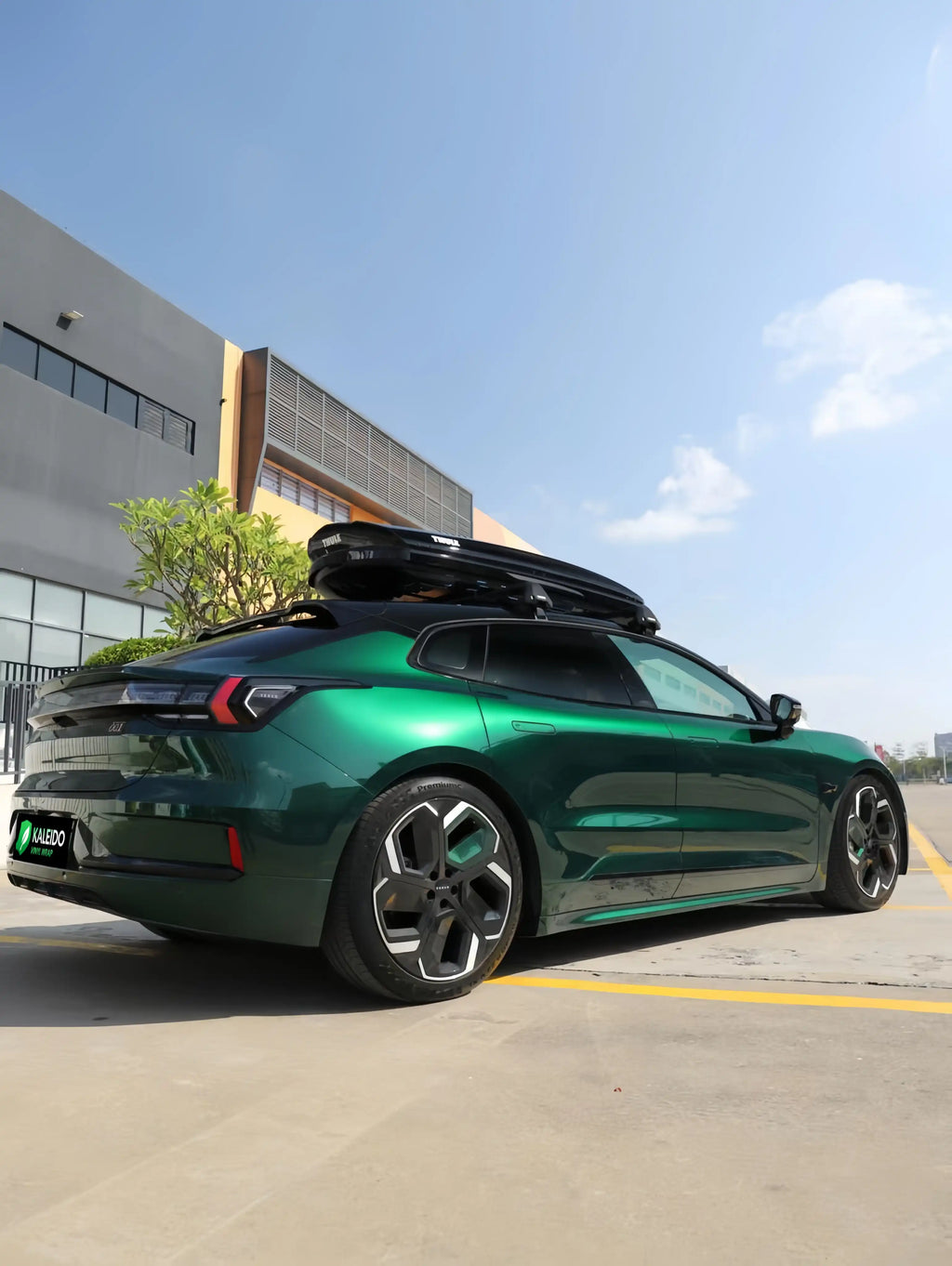 Zeekr 001 in Gloss Metallic Agate Green vinyl wrap - rear-right view showing rich green metallic finish - Kaleido