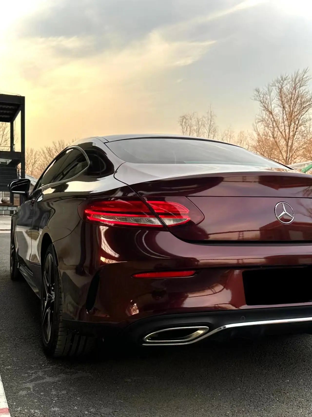 Close-up rear-left view of Mercedes C-Class Coupe in Gloss Metallic Black Rose wrap - Kaleido