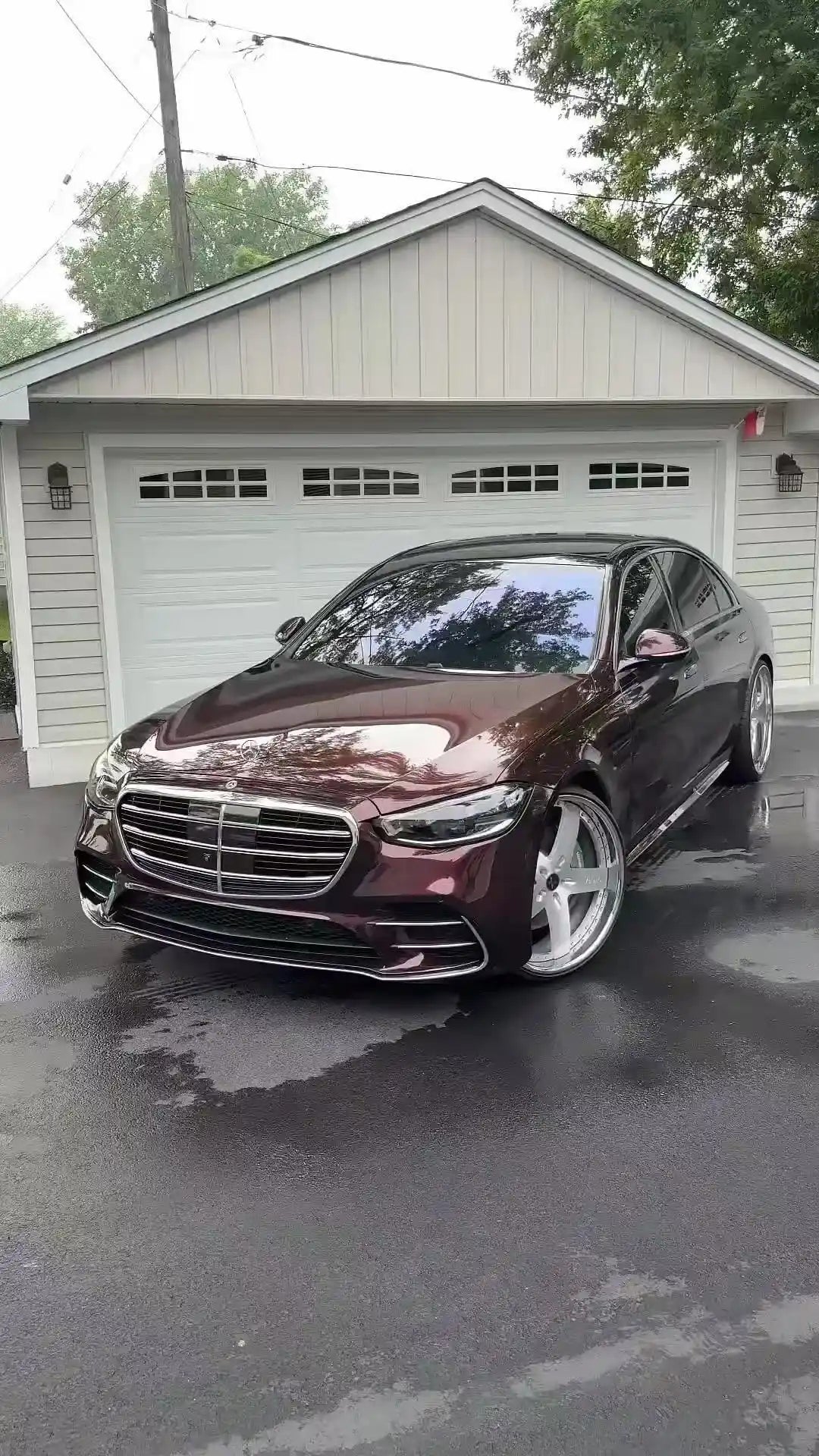 Wide front-left view of Mercedes-Benz S-Class in Gloss Metallic Black Rose vinyl wrap - Kaleido