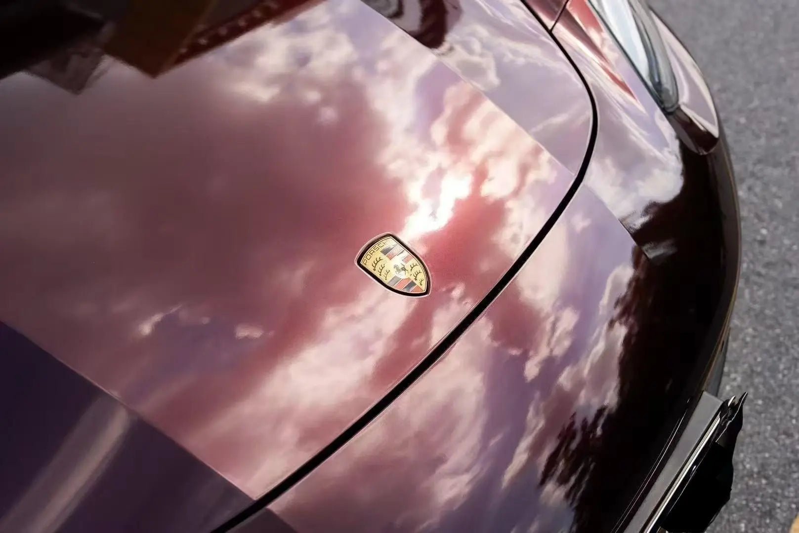 Macro detail of Gloss Metallic Black Rose wrap on Porsche Panamera hood - purple-red metallic flakes - Kaleido