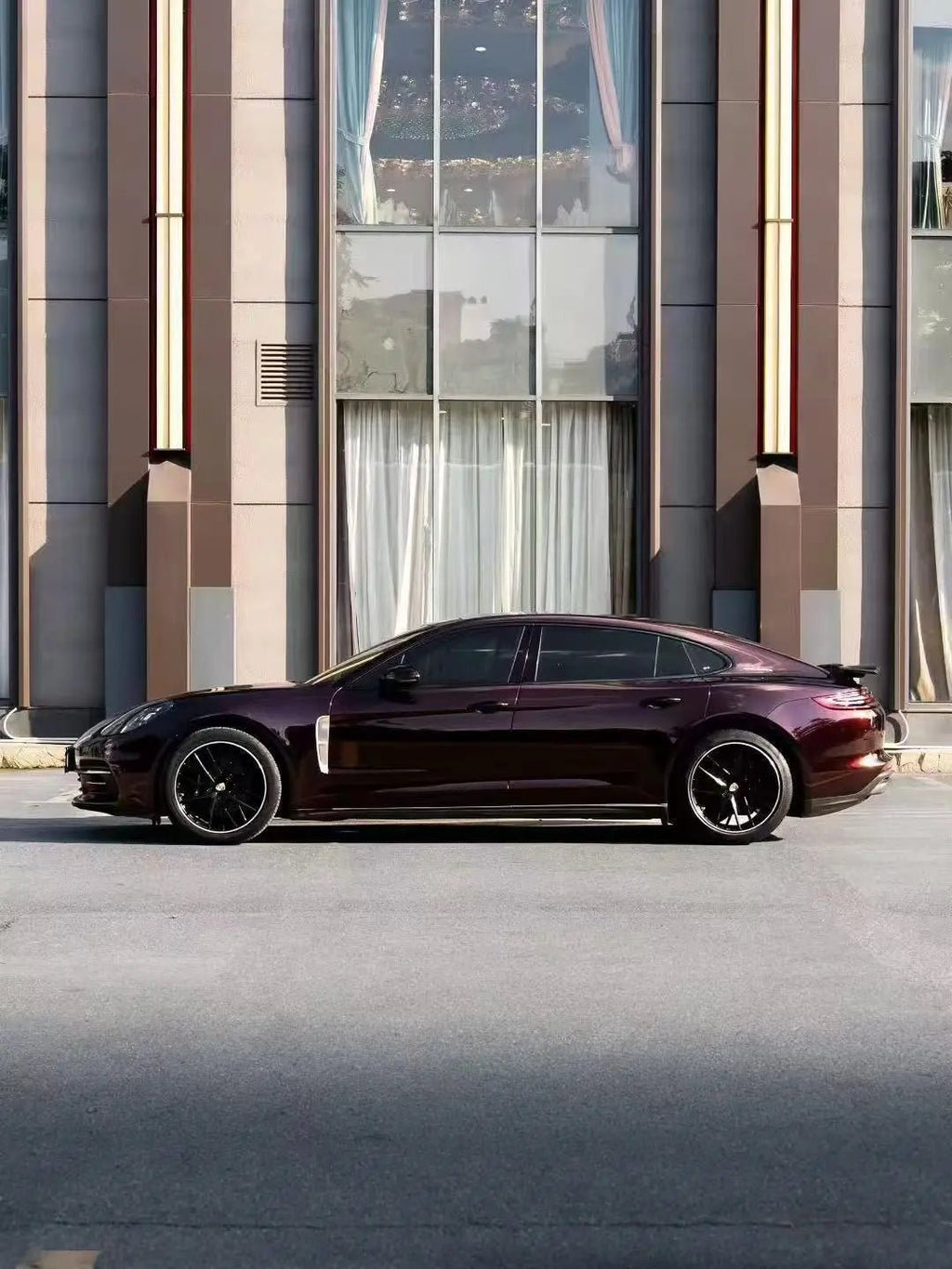 Left side profile of Porsche Panamera with Gloss Metallic Black Rose film - Kaleido
