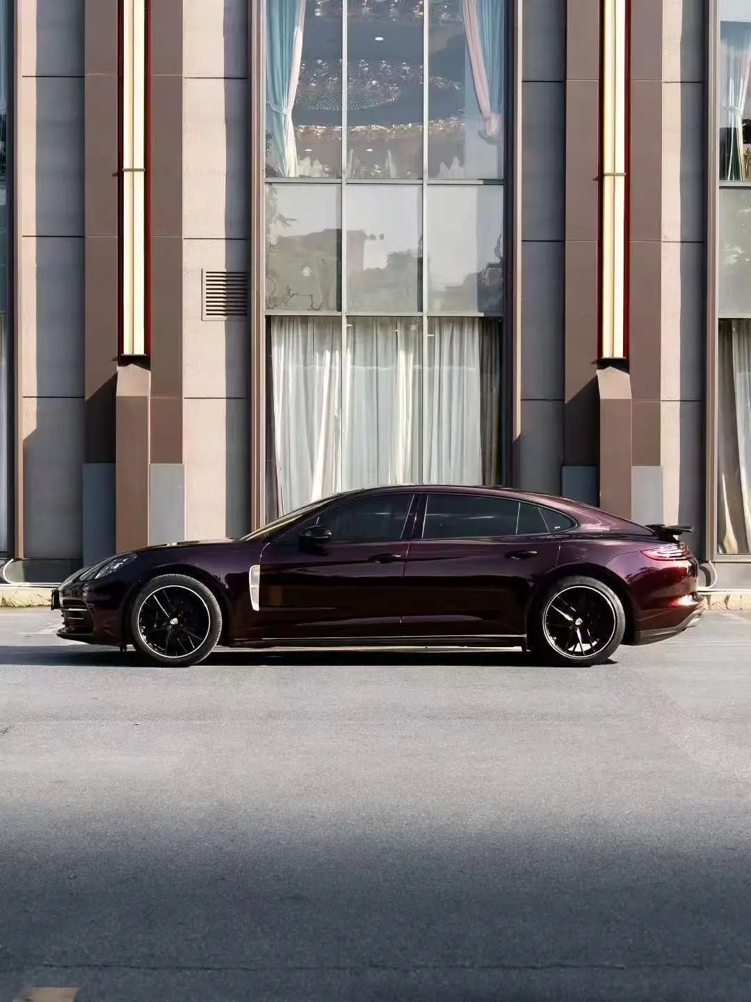 Left side profile of Porsche Panamera with Gloss Metallic Black Rose film - Kaleido