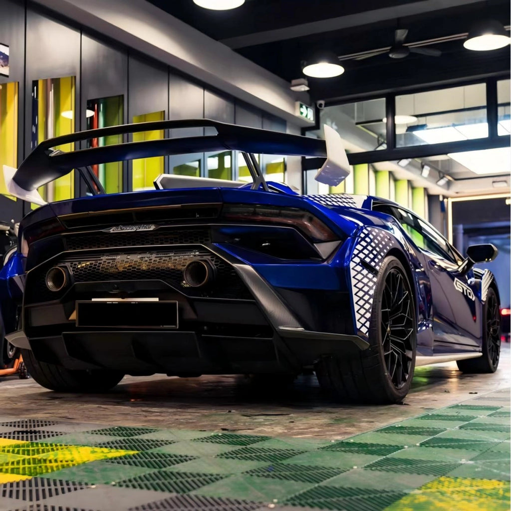 Low-angle rear shot of Deep Blueberry Metallic wrapped Huracán STO - emphasizing exhaust and wing design - Kaleido