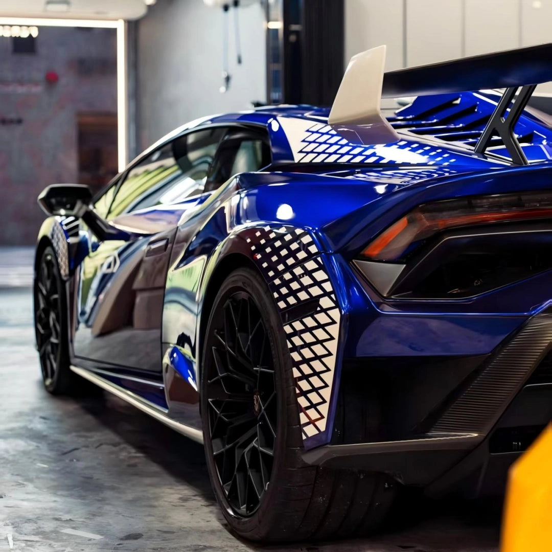 Deep Blueberry Metallic wrap on Lamborghini Huracán STO - rear wheel and bodywork showcasing livery design - Kaleido