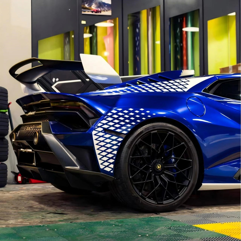 Rear-top angle of Deep Blueberry Metallic Lamborghini Huracán STO - highlighting wing and rear quarter panel - Kaleido