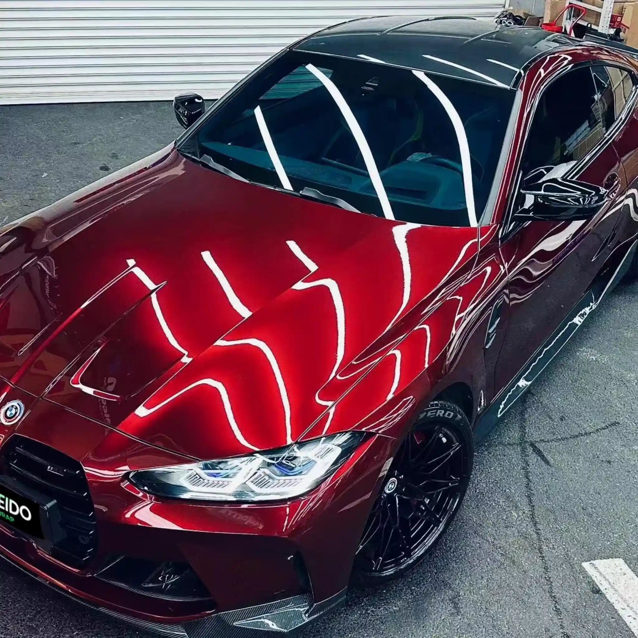 Top-down front-left view of BMW M2 in Gloss Metallic Dragon Blood wrap - Kaleido