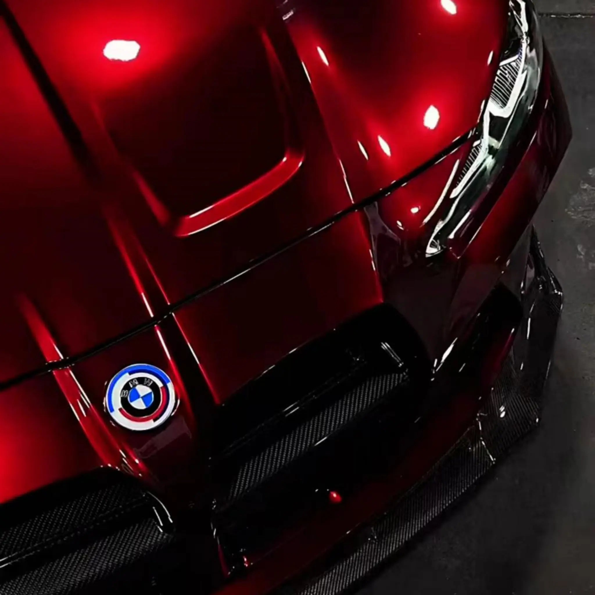 Close-up of Gloss Metallic Dragon Blood vinyl on BMW M2 hood - intense deep red metallic finish - Kaleido