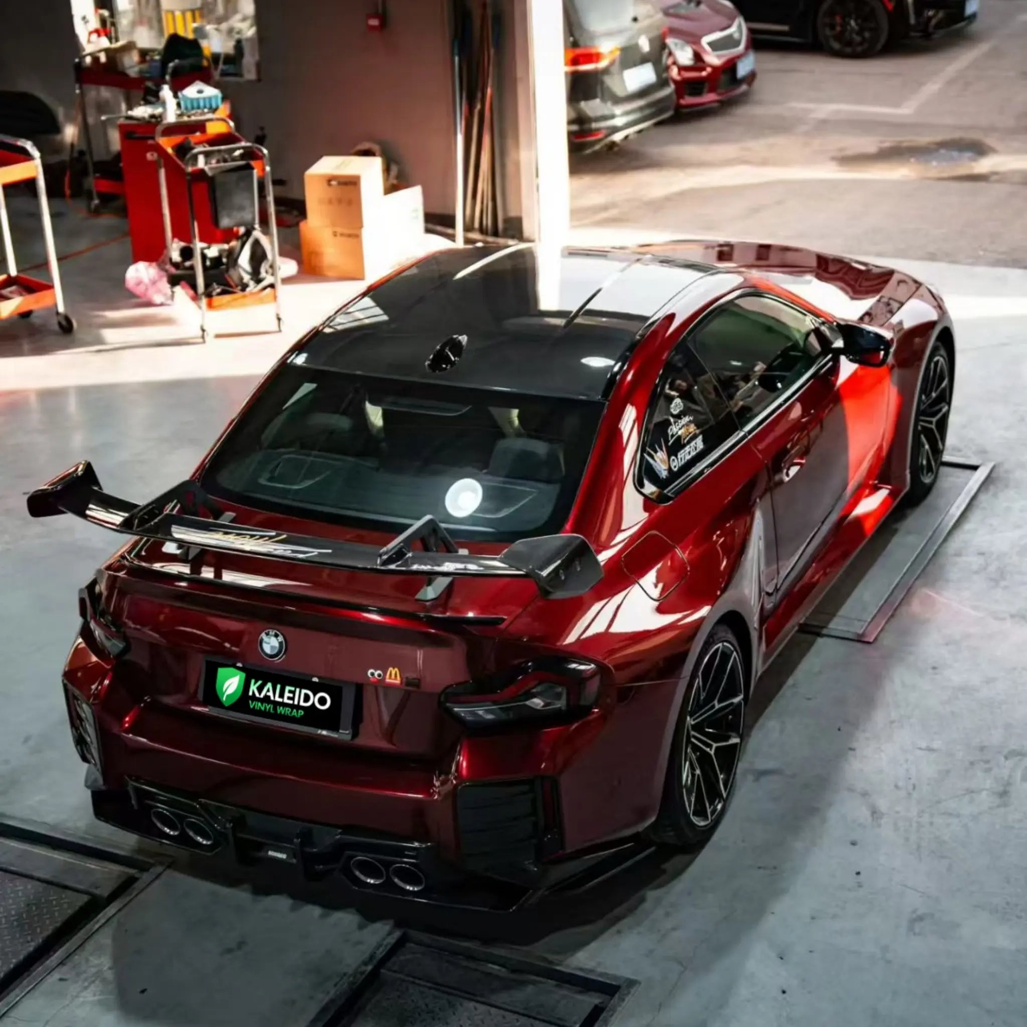Top-down rear-right view of Gloss Metallic Dragon Blood wrapped BMW M2 - Kaleido