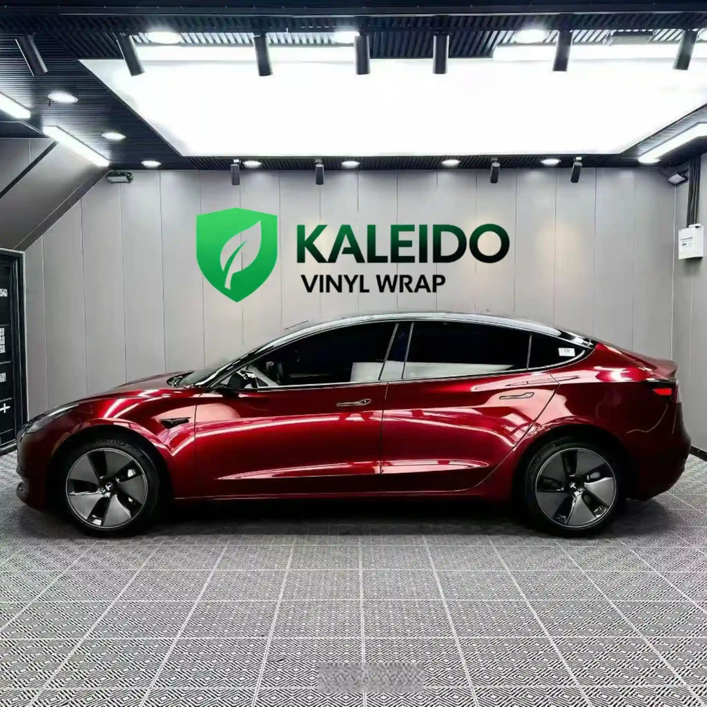Left side profile of Tesla Model 3 in Gloss Metallic Dragon Blood vinyl wrap - Kaleido