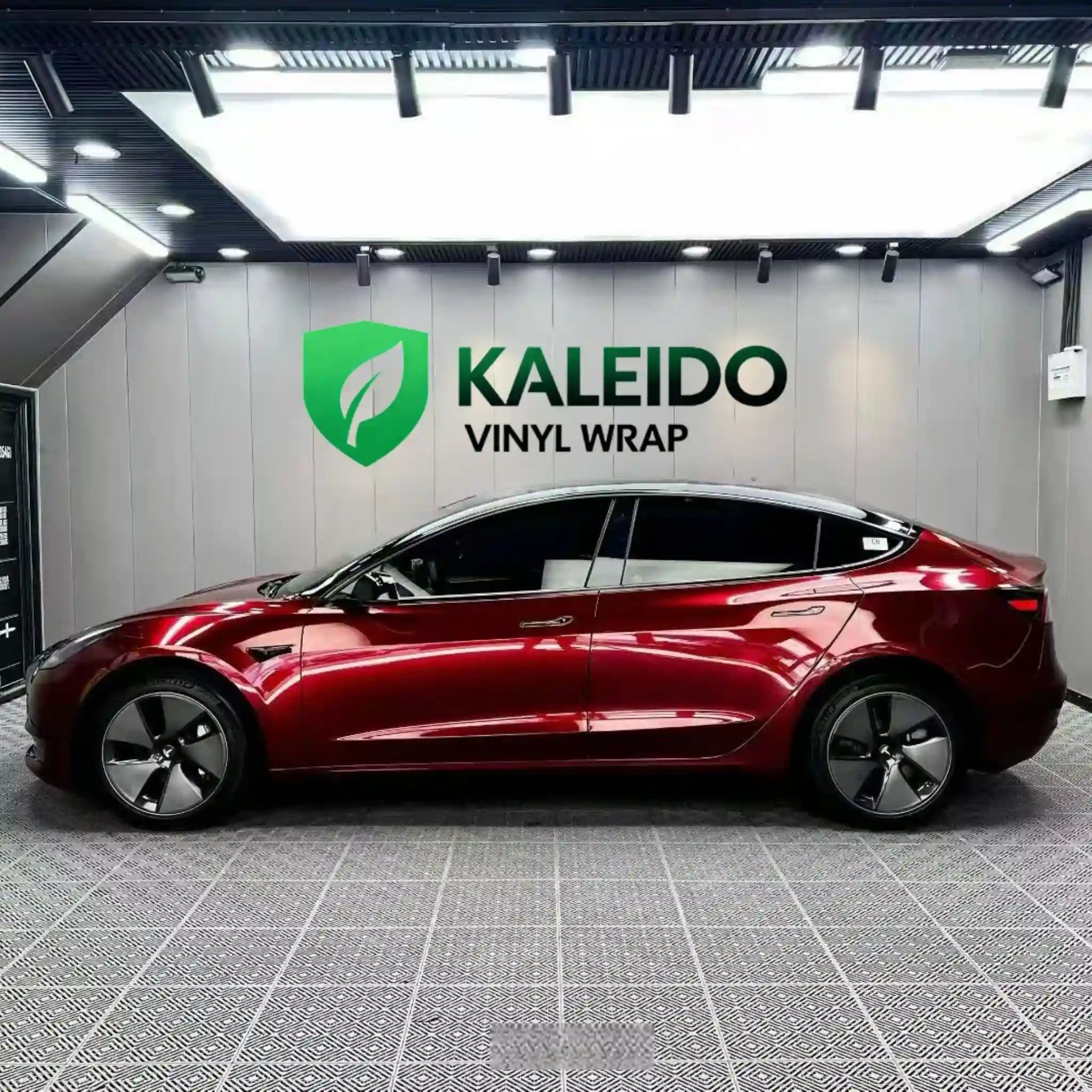 Left side profile of Tesla Model 3 in Gloss Metallic Dragon Blood vinyl wrap - Kaleido