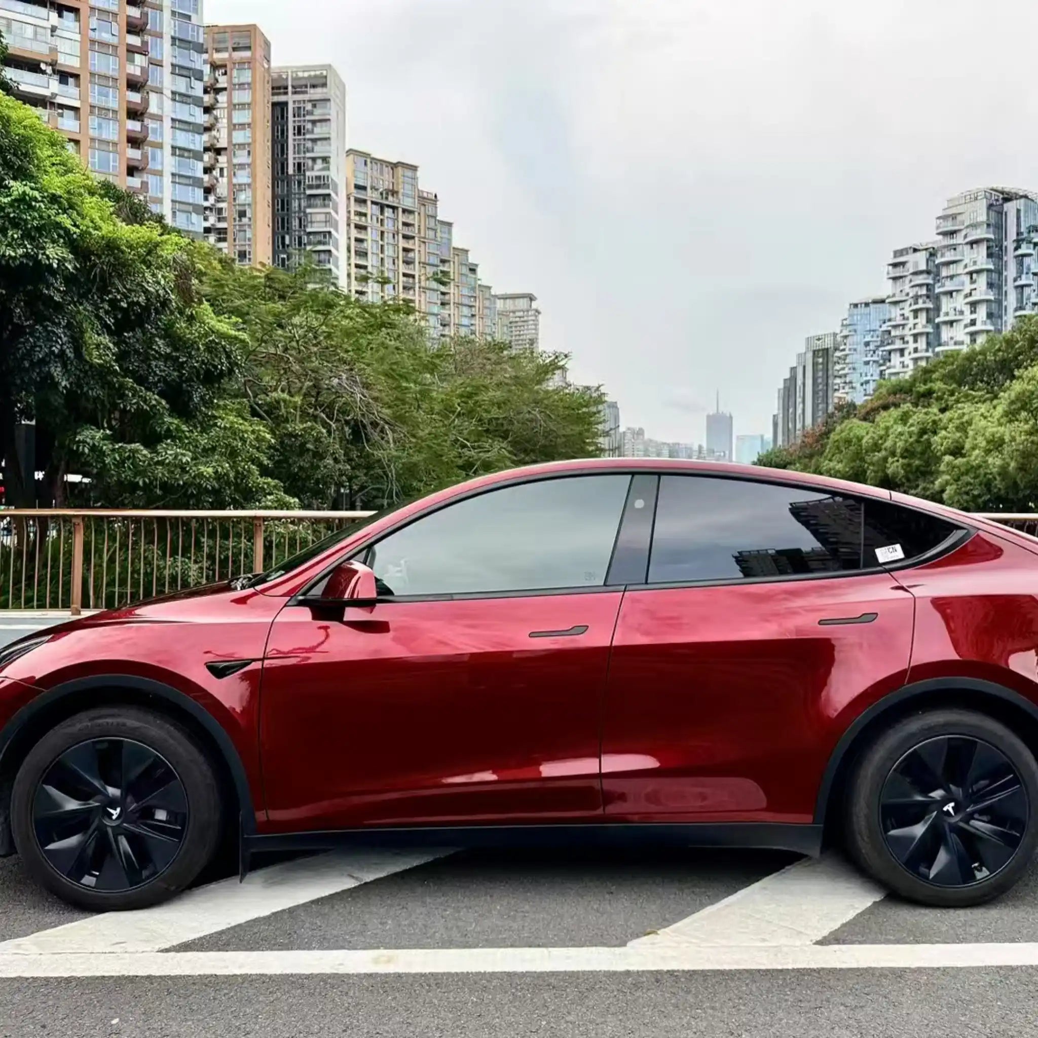 Panoramic left side view of Tesla Model Y wrapped in Gloss Metallic Dragon Blood - Kaleido