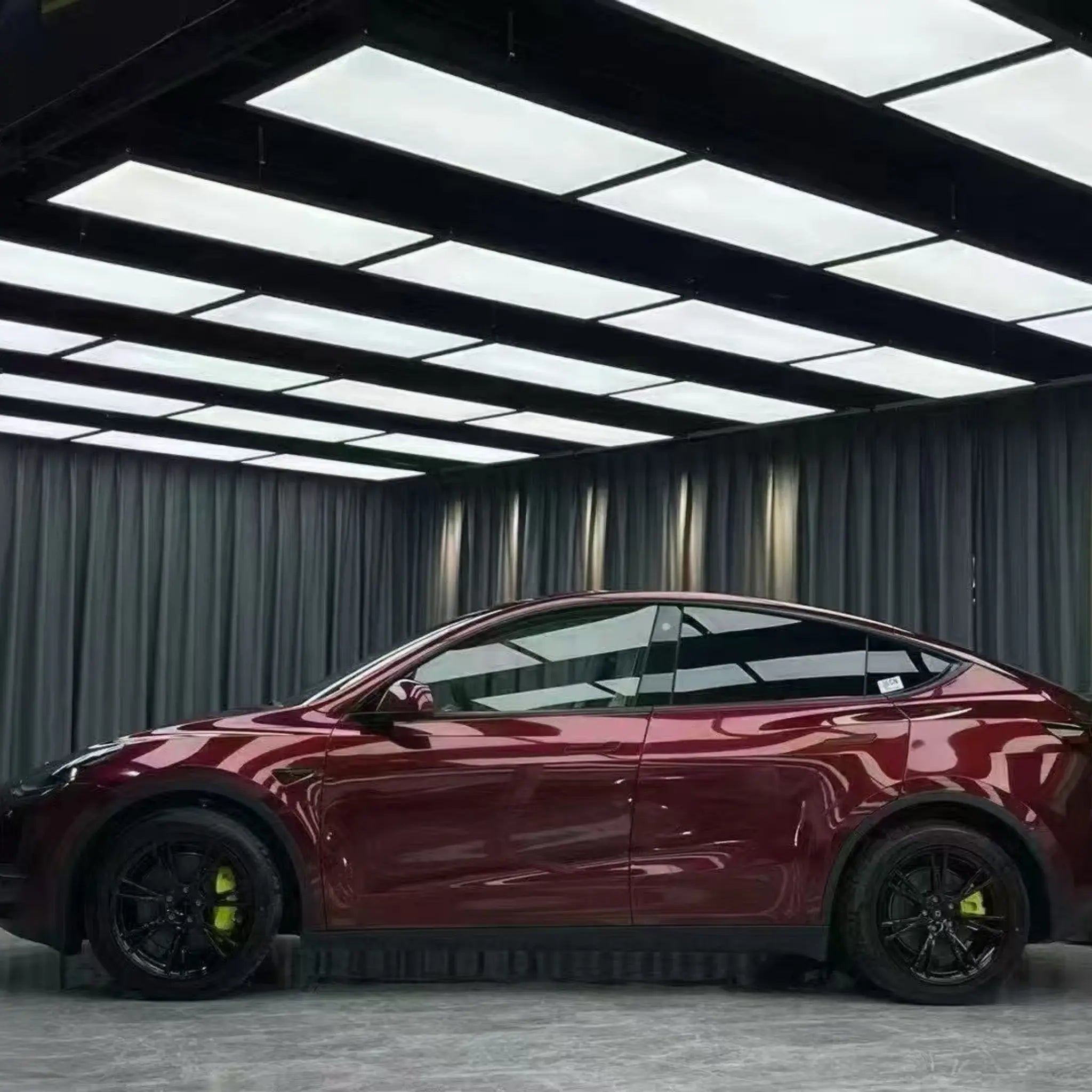 Left side profile of Tesla Model Y with Gloss Metallic Dragon Blood vinyl wrap - Kaleido