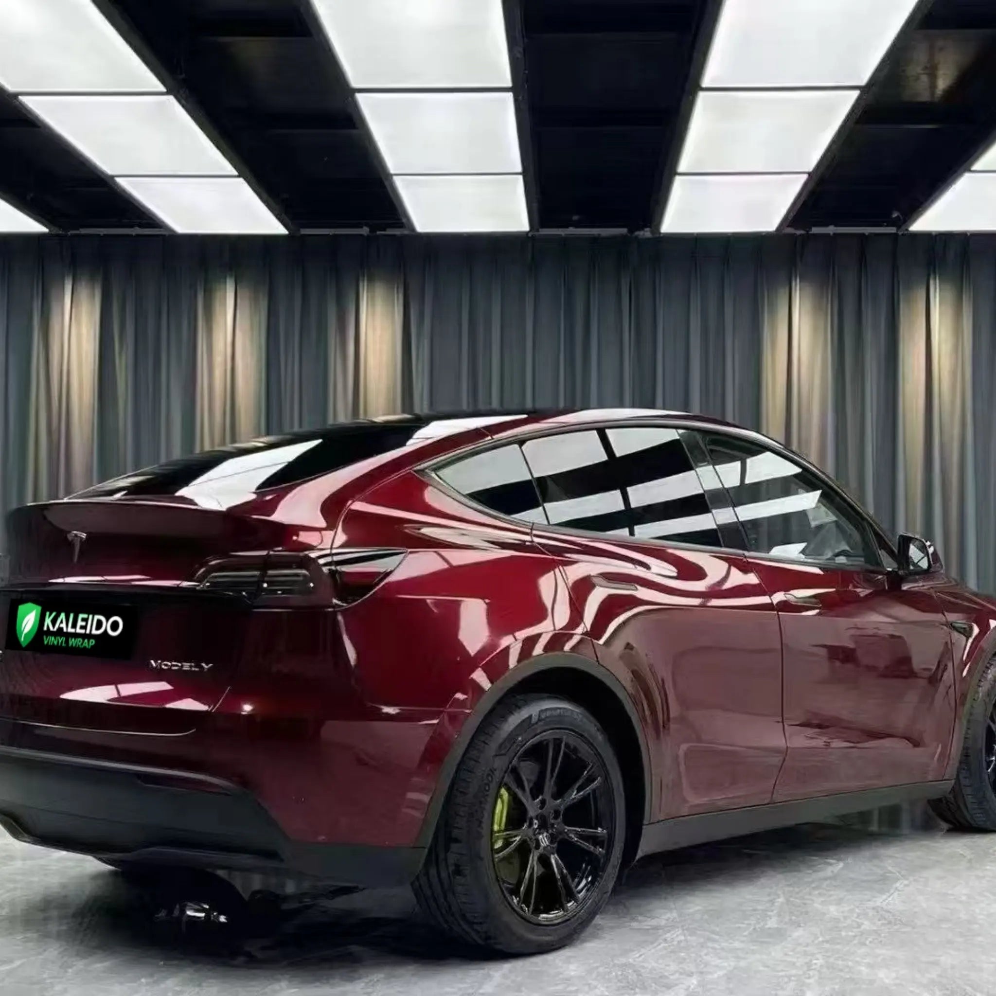 Tesla Model Y in Gloss Metallic Dragon Blood wrap - rear-right view of SUV - Kaleido