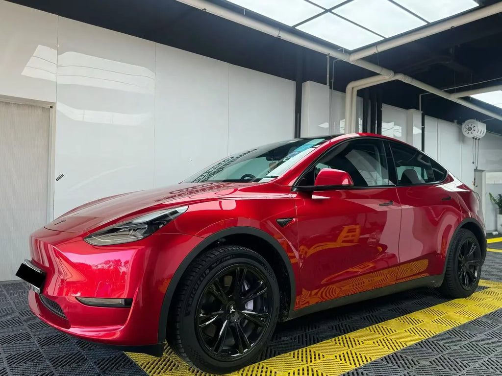 Gem Red gloss metallic vinyl on Tesla Model Y front-left - elegant color presentation - Kaleido