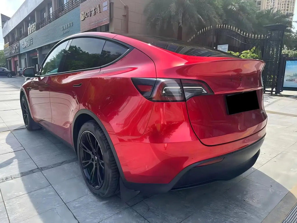 Gem Red gloss metallic wrap on Tesla Model Y rear-quarter left - showcasing SUV contour - Kaleido