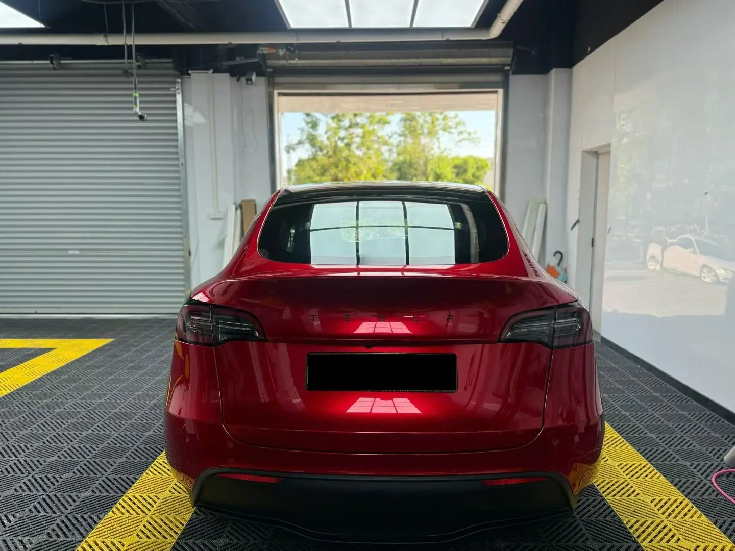 Rear view of Tesla Model Y in Gem Red gloss metallic vinyl - full tailgate presentation - Kaleido