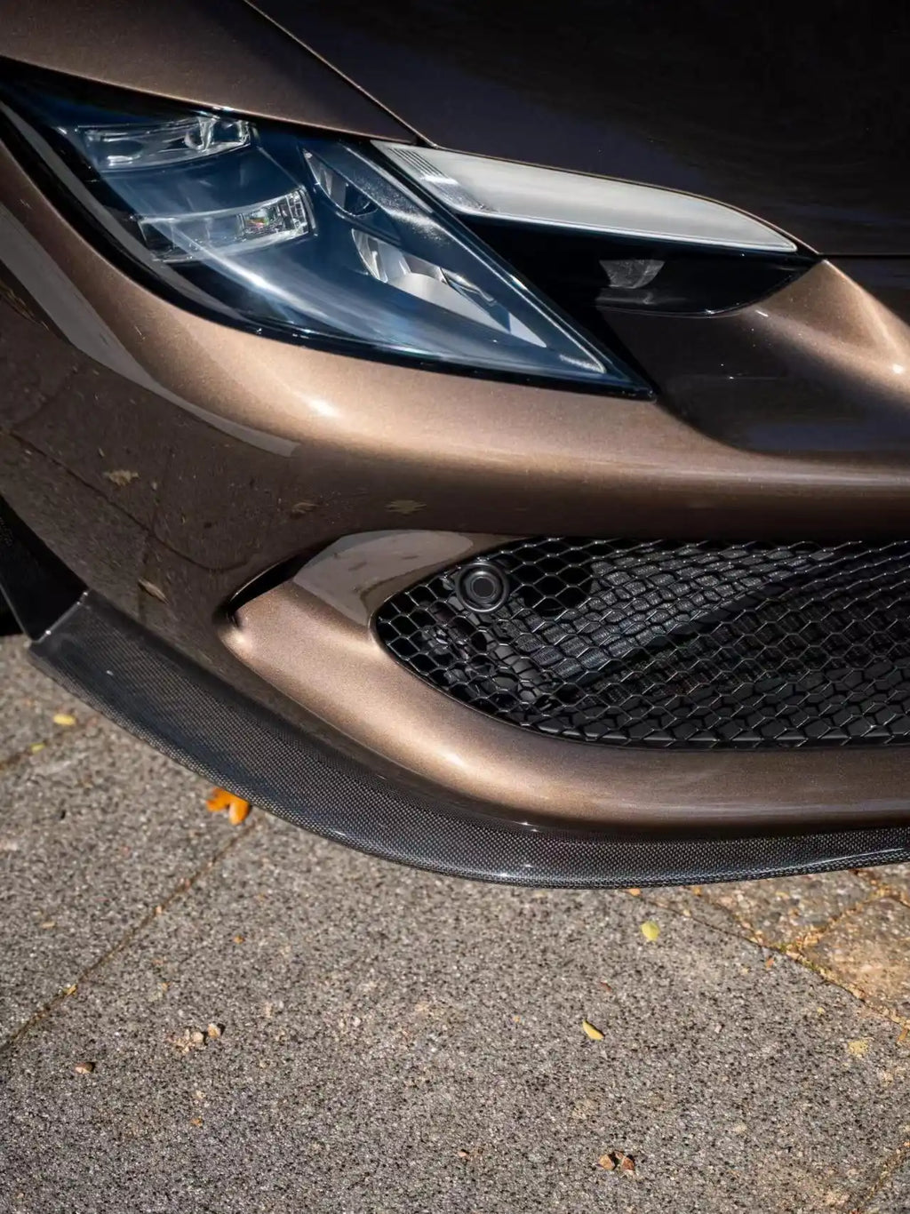 Close-up of Mocha Truffle film on Ferrari 296 GTS headlight - precise edge work - Kaleido