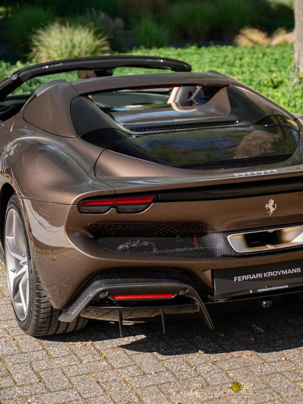 Rear view of Ferrari 296 GTS in Mocha Truffle metallic - showcasing exhaust and diffuser - Kaleido
