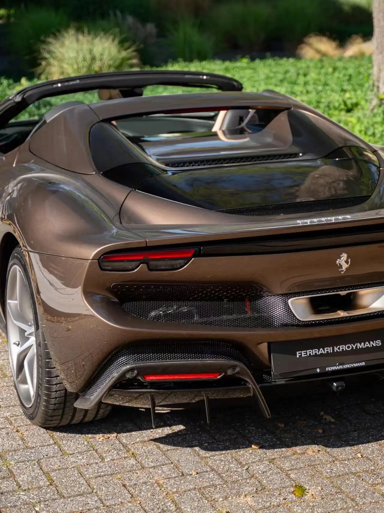 Rear view of Ferrari 296 GTS in Mocha Truffle metallic - showcasing exhaust and diffuser - Kaleido