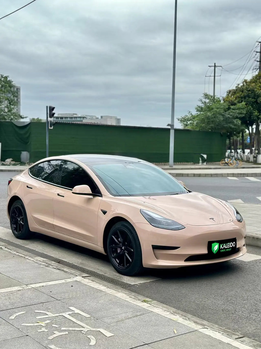 Tesla Model 3 in Gloss Milktea vinyl wrap - front-right 45-degree angle - Kaleido