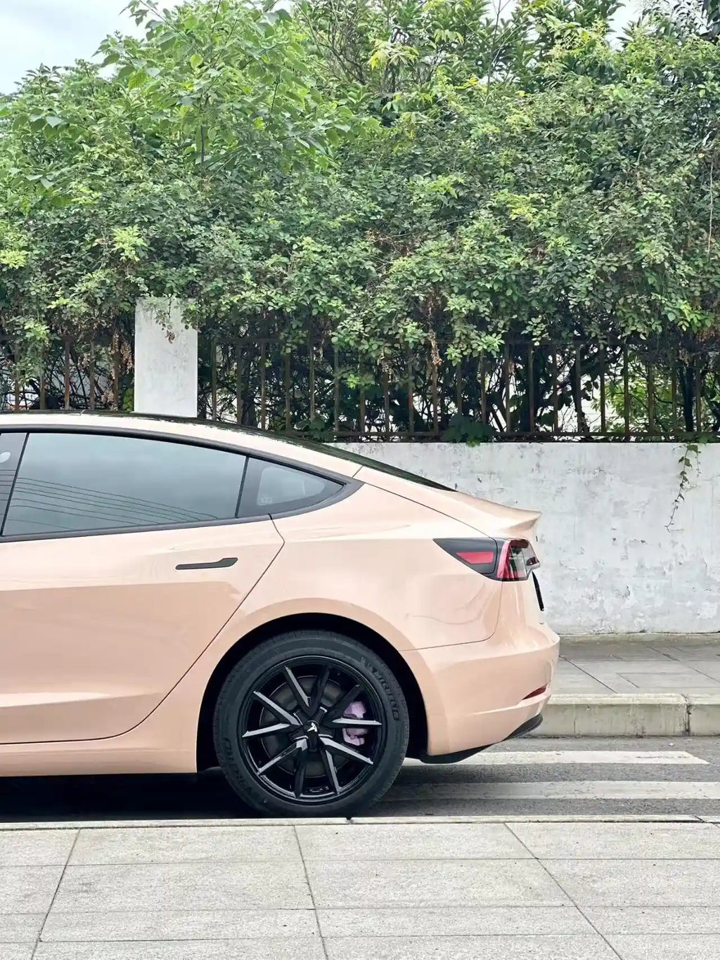 Gloss Milktea wrap on Tesla Model 3 left rear corner - warm beige finish - Kaleido