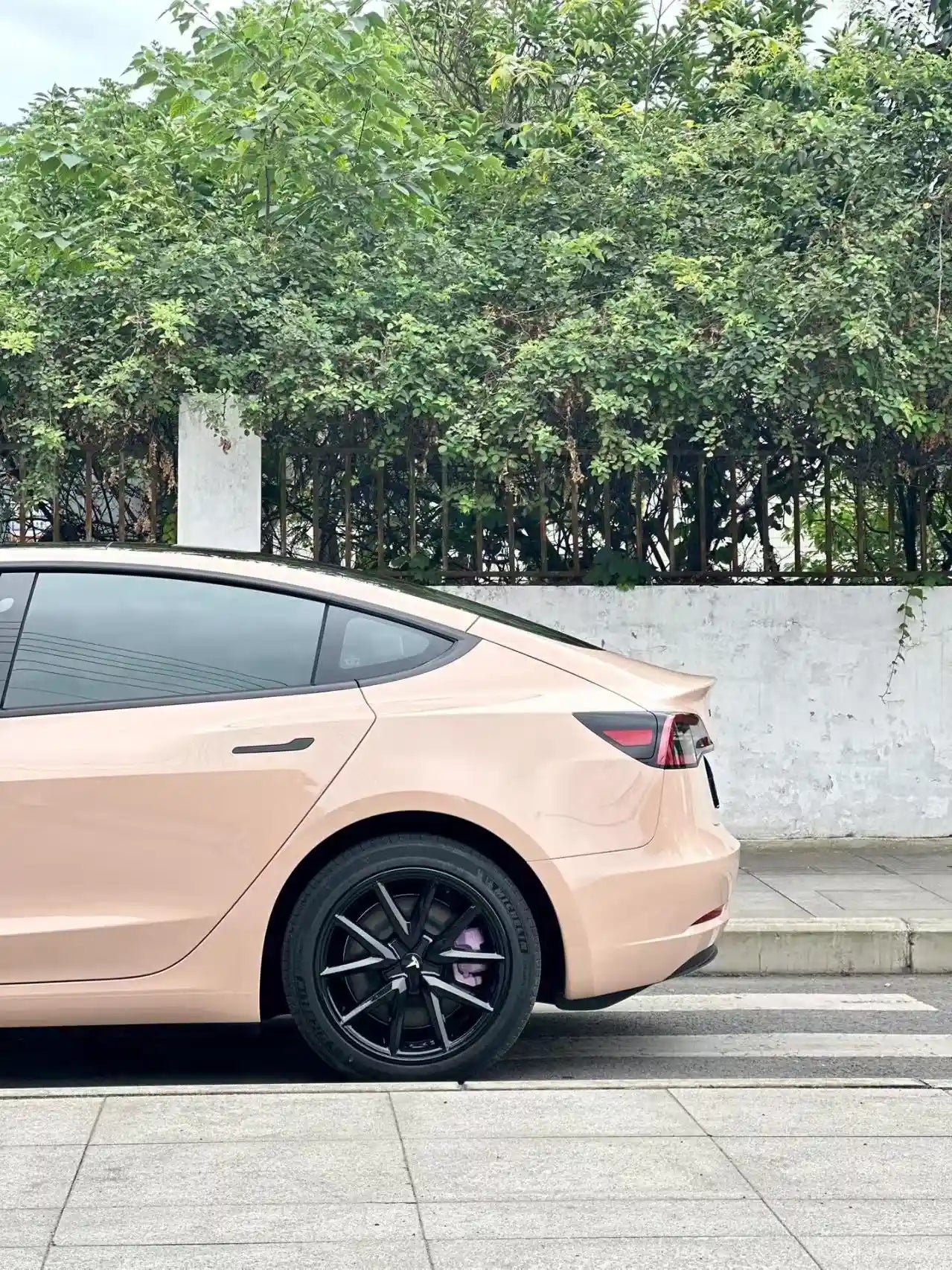 Gloss Milktea wrap on Tesla Model 3 left rear corner - warm beige finish - Kaleido
