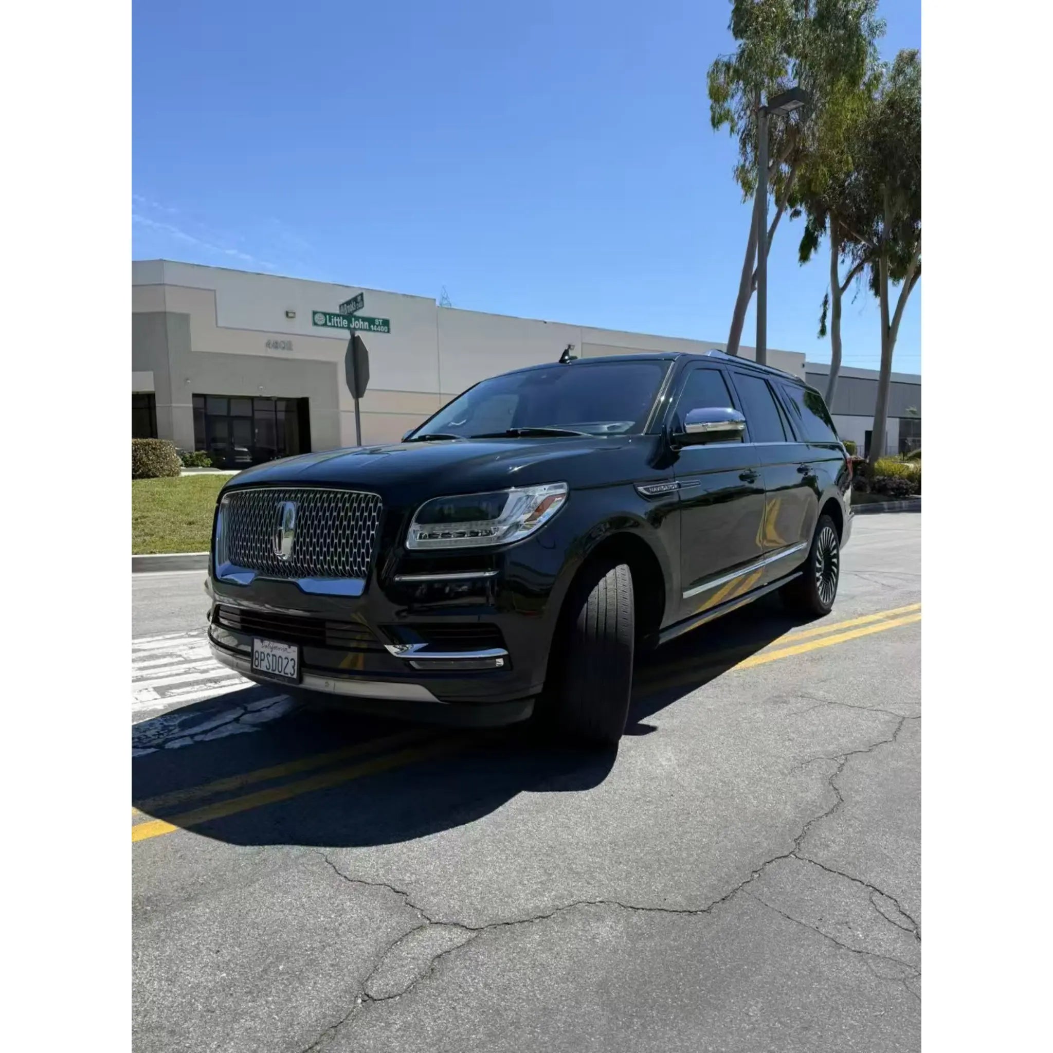 Gloss Piano Black vinyl wrap on the front-left side of a Lincoln Navigator - Kaleido