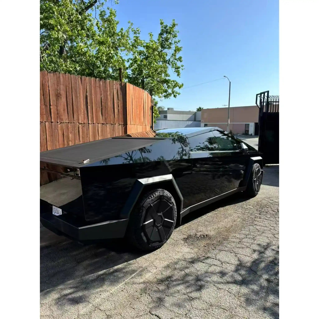 Gloss Piano Black wrap, rear-right angle of the Tesla Cybertruck - Kaleido