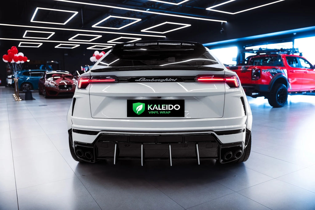 Rear view of a Gloss Piano White wrapped Lamborghini Urus luxury SUV - Kaleido