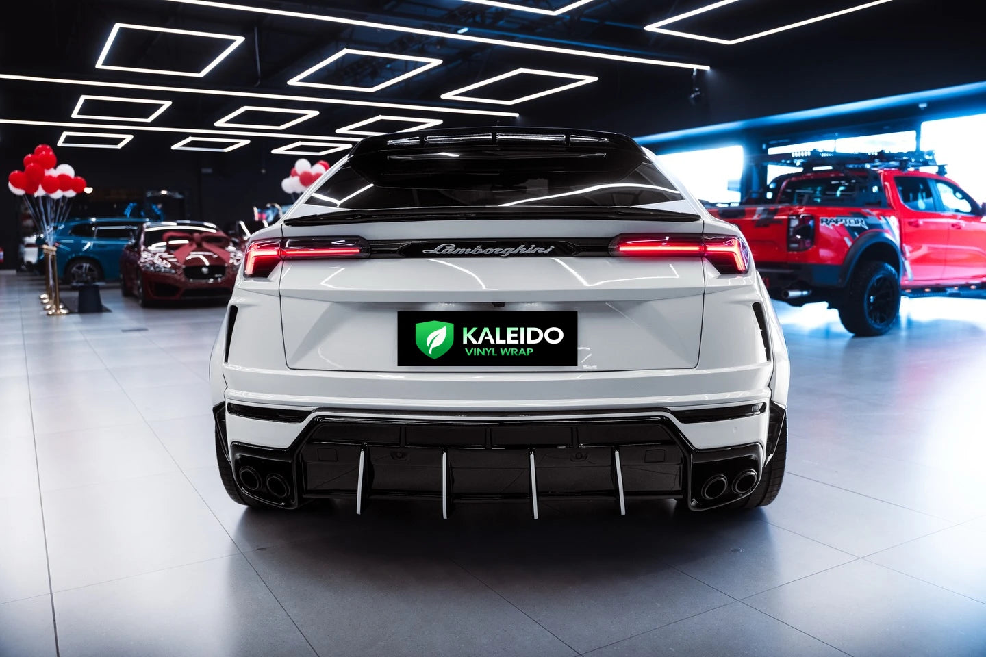 Rear view of a Gloss Piano White wrapped Lamborghini Urus luxury SUV - Kaleido