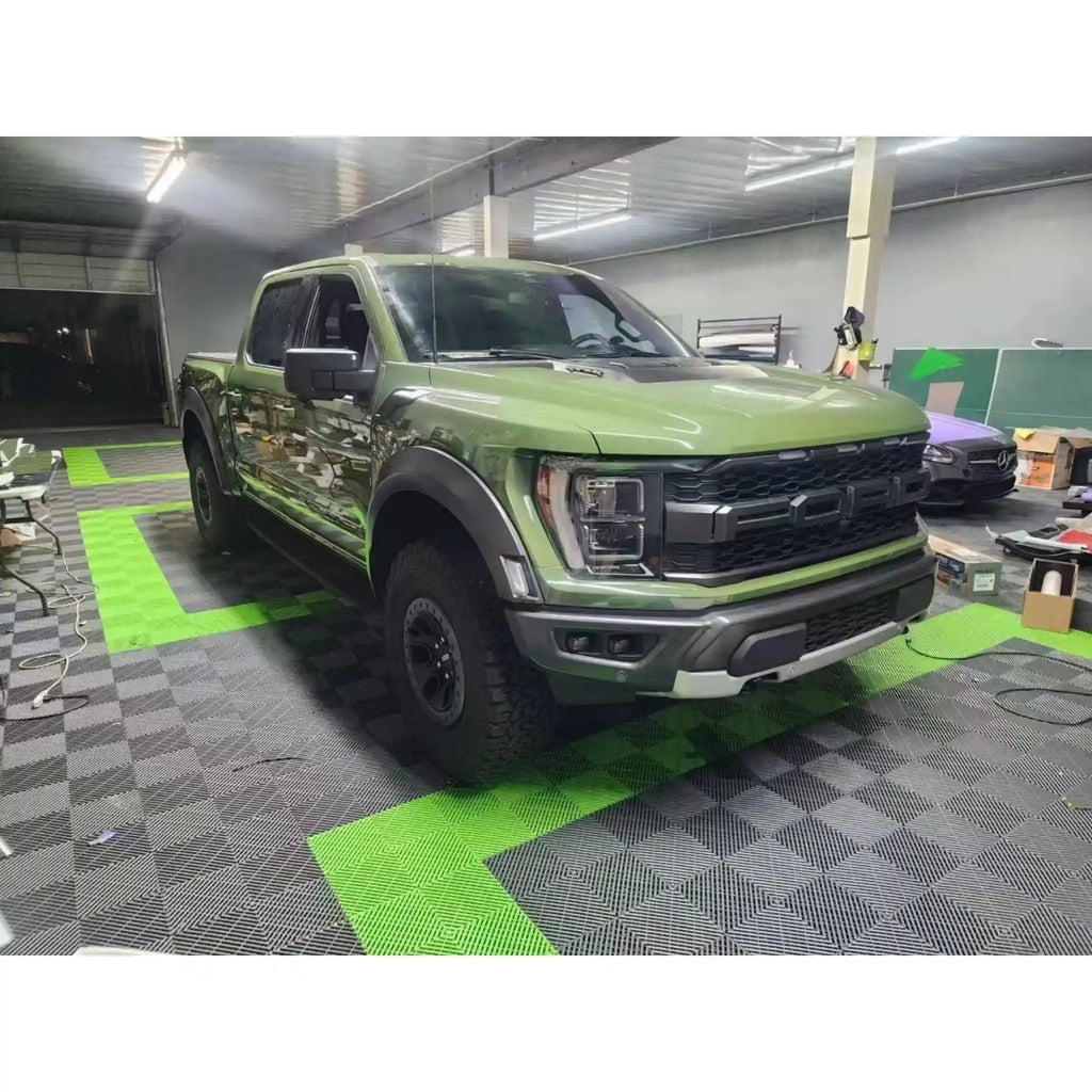 Gloss Porsche Olive Green wrap on Ford F-150 Raptor - front-right rugged angle - Kaleido