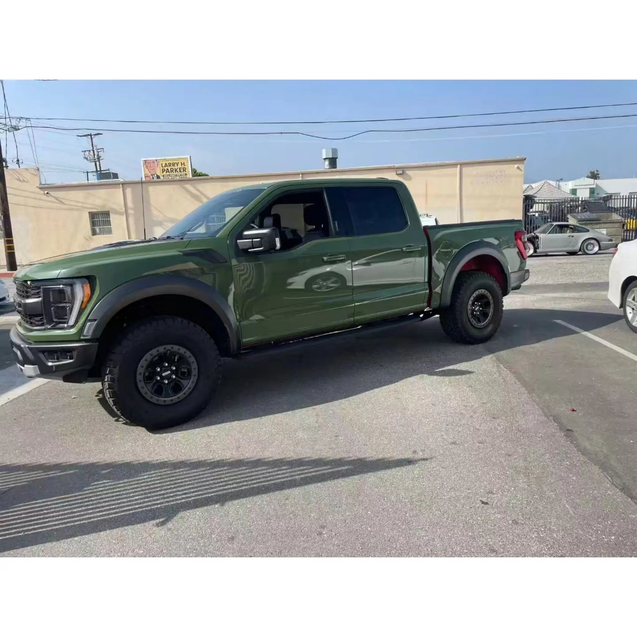 Ford F-150 Raptor in Gloss Porsche Olive Green vinyl wrap - full side view on a truck - Kaleido