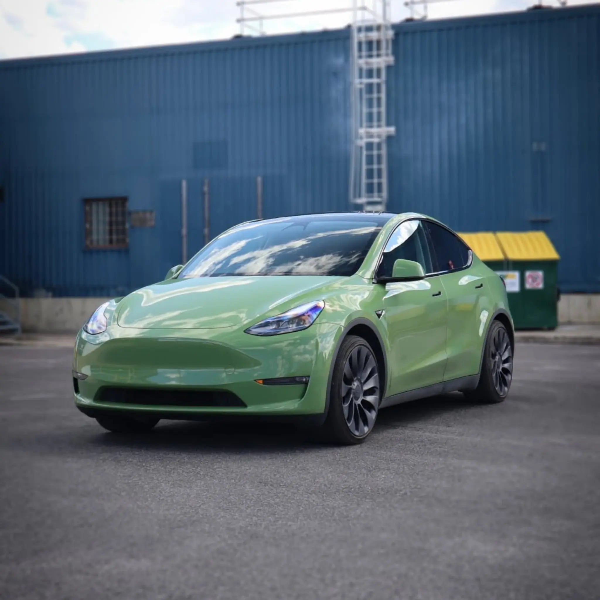 Gloss Porsche Olive Green vinyl on Tesla Model Y - front-left angle - Kaleido
