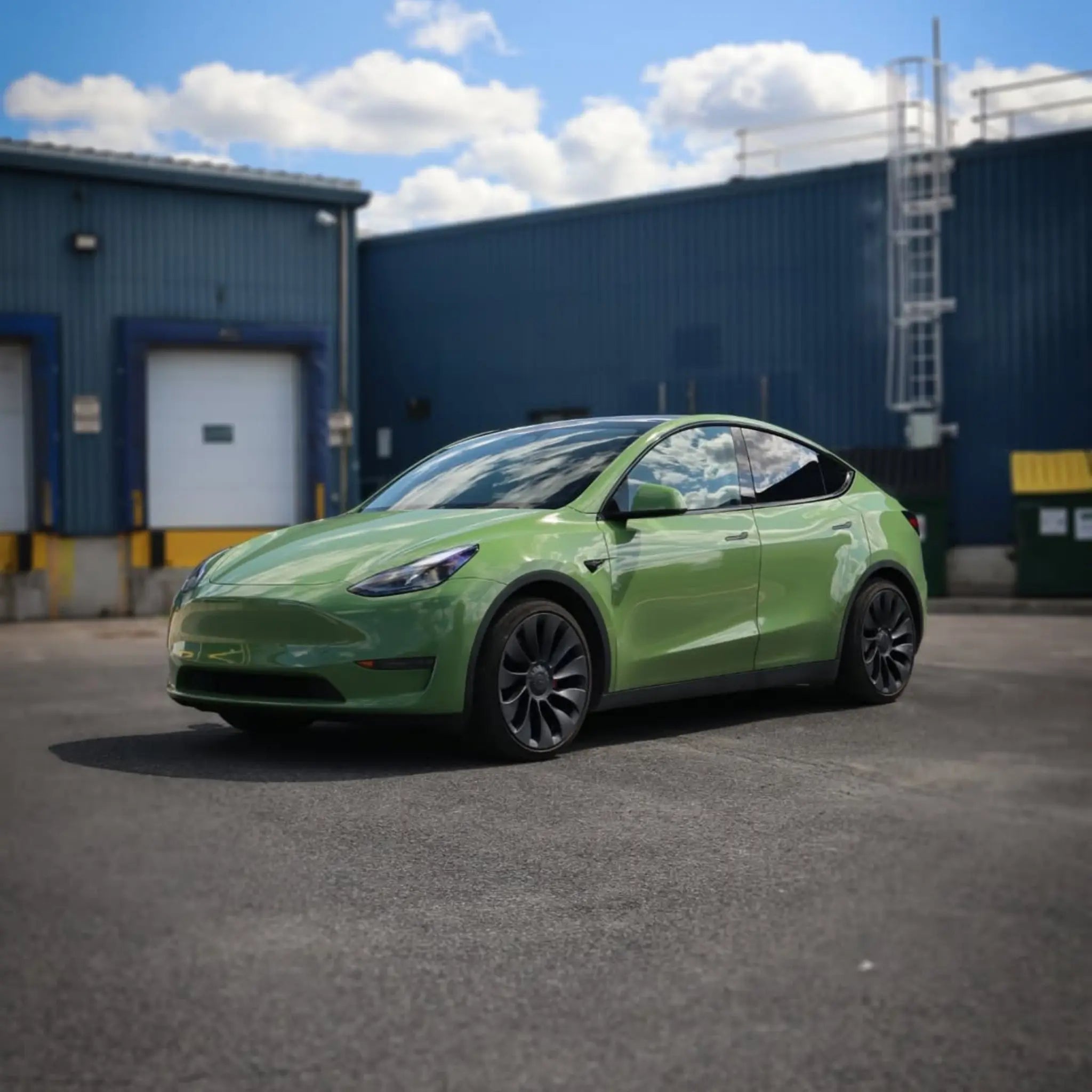 Wide front-left view of Tesla Model Y in Gloss Porsche Olive Green - Kaleido